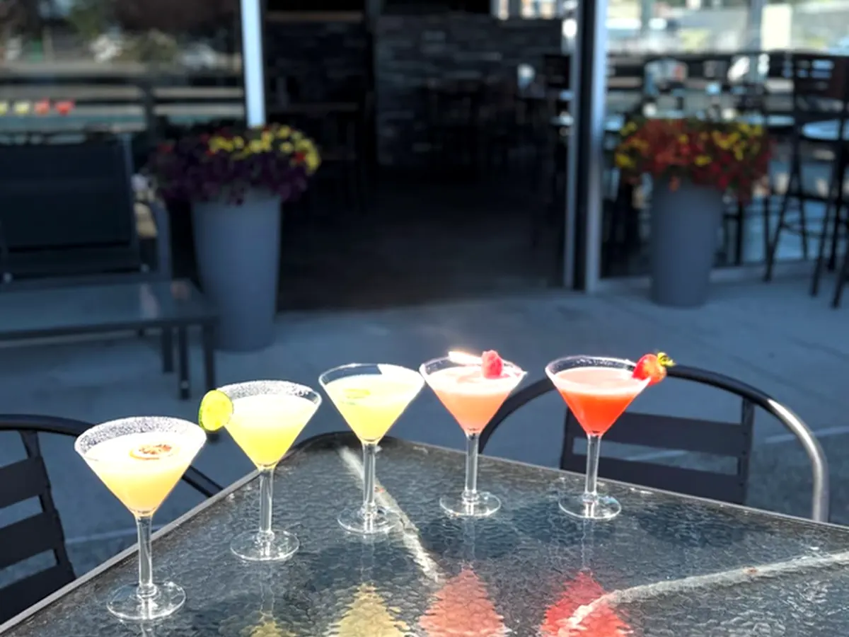 Colorful cocktail flight on the Glow Martini Lounge patio